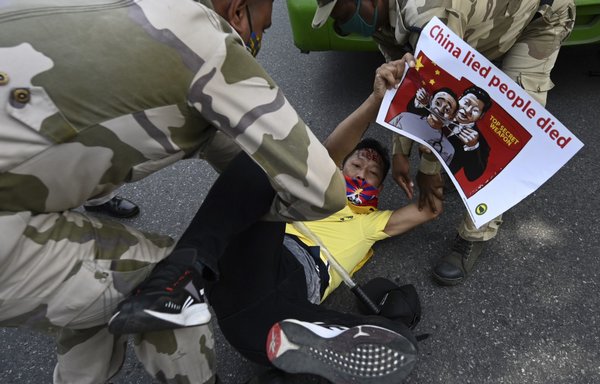 A Tibetan exile activist is detained by Indian police during a protest to commemorate the anniversary of the 1959 Tibetan uprising against Chinese rule, outside the Chinese embassy in New Delhi on March 10, 2021. [Money Sharma/AFP]