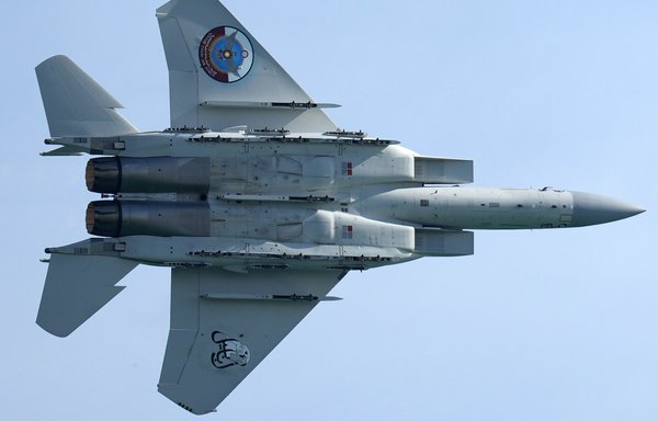 A Qatar Emiri Air Force F-15 Eagle tactical fighter aircraft performs manoeuvres in the sky above Qatar's capital Doha as the Gulf state marks its National Day on December 18, 2021. [ AFP]