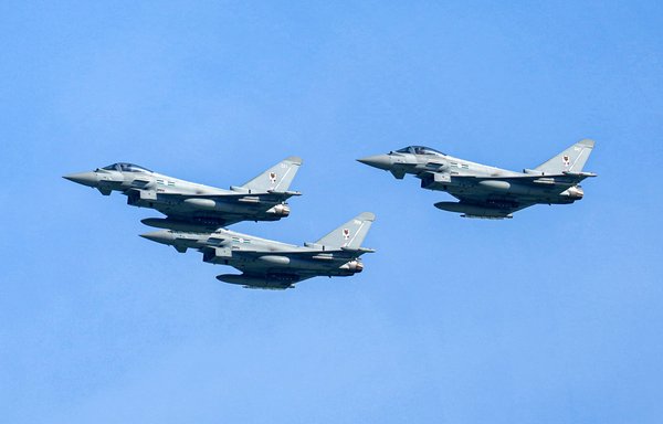 Qatar Emiri Air Force Eurofighter Typhoon fighter aircraft perform manoeuvres in the sky above Qatar's capital Doha as the Gulf state marks its National Day on December 18, 2021. [AFP]
