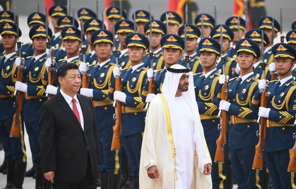Abu Dhabi Crown Prince Mohammed bin Zayed Al Nahyan reviews a military honour guard with Chinese President Xi Jinping during a ceremony in Beijing on July 22, 2019. [Greg Baker/AFP]