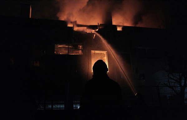 Firefighters extinguish a fire after a Russian drone attack in the Ukrainian capital, Kyiv, in March. Estimates suggest Iran has supplied Russia with over 400 suicide drones for its attacks against Ukraine. [Sergey SHESTAK / AFP]