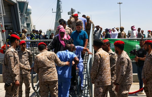 Evacuees from Sudan disembark from a ship upon their arrival in Jeddah on April 30. [Fayez Nureldine/AFP]