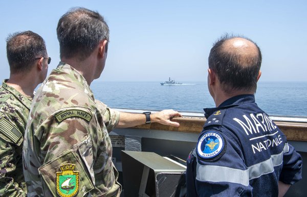 US, UK and French commanders aboard guided-missile destroyer USS Paul Hamilton observe a UK frigate passing by while transiting the Strait of Hormuz on May 19. [US Navy]