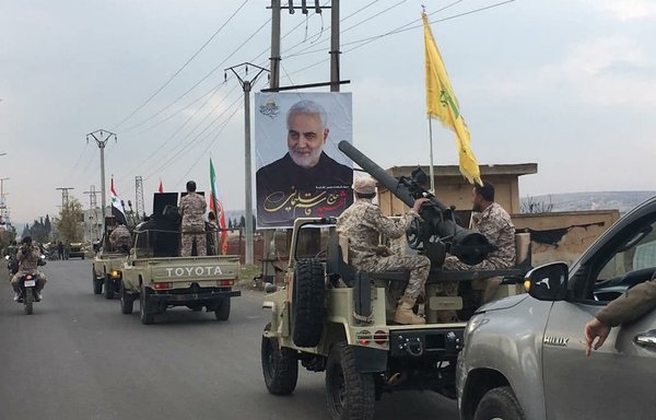 Iran-aligned militias January 2, 2021, in Aleppo province, Syria, take part in a parade commemorating the killing of IRGC Quds Force commander Qassem Soleimani. Soleimani was killed in Baghdad in January 2020. [QalaatM Twitter account]