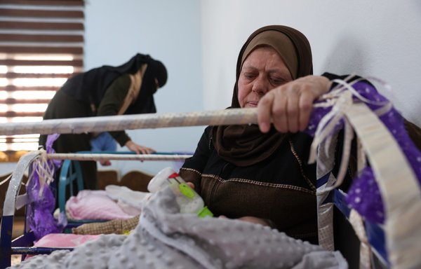 Nurses care for babies at the 'Child Houses' centre in Idlib which shelters Syrian unaccompanied children and those of unknown parentage. [Omar Haj Kadour/AFP]