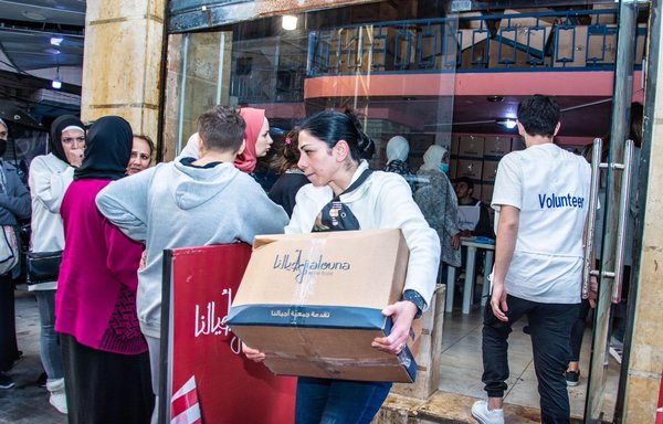 Ajialouna Association volunteers stay busy preparing food rations, packing them and transporting them on trucks to be distributed to the poor. [Ajialouna Association]