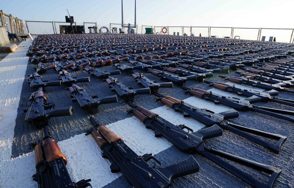 Thousands of AK-47 assault rifles sit on the flight deck of guided-missile destroyer USS The Sullivans during an inventory process on January 7. US naval forces seized 2,116 AK-47 assault rifles from a fishing vessel transiting along a maritime route from Iran to Yemen. [US Navy]