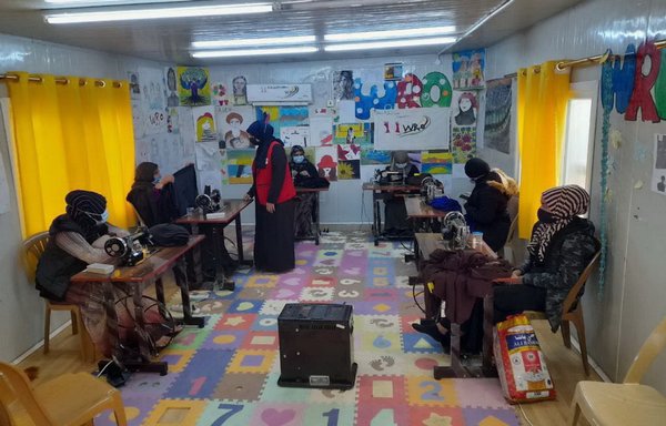 Iraqi women repatriated from Syria's al-Hol camp take sewing lessons at al-Jadaa Rehabilitation Centre near Mosul on May 27, 2021. [Iraqi Ministry of Migration and Displacement]