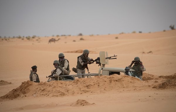 Mauritanian soldiers stand guard at a G5 Sahel task force command post on November 22, 2018, near the border with Mali. Remote villages near the border with Mali have been prey to extremists and other armed groups that have proliferated in Africa's Sahel region. [Thomas Samson/AFP]
