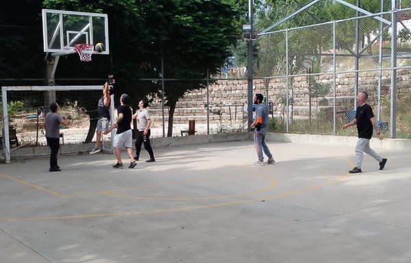 Men play basketball at a drug rehabilitation centre in Lebanon. [Karyet el-Ensen/Father Majdi Allawi]