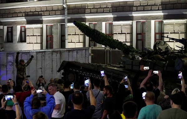 Members of the Wagner Group prepare to pull out from the military headquarters of Rostov-on-Don on June 24 amid much fanfare from local residents. [Stringer/AFP]