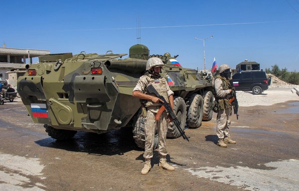 Russian soldiers stand by an armoured personnel carrier in Daraa al-Balad district in southern Syria on September 6, 2021. [Sam Hariri/AFP]