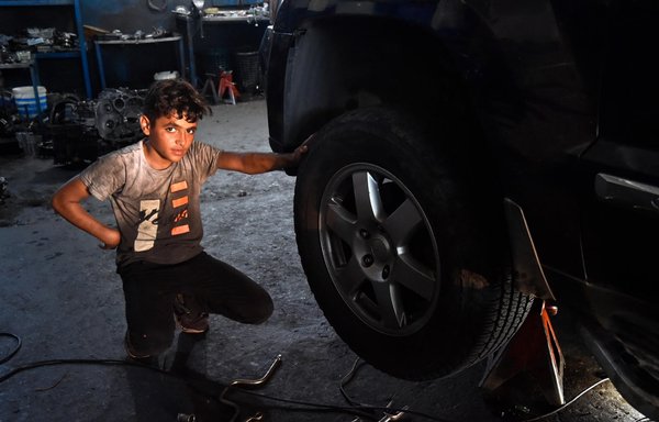 Teenage Syrian refugee Abdel Kader Al-Shami was forced to quit school and work in a tire shop in Sin al-Fil because of the stifling economic crisis in Lebanon. [Ziad Hatem/Al-Mashareq]