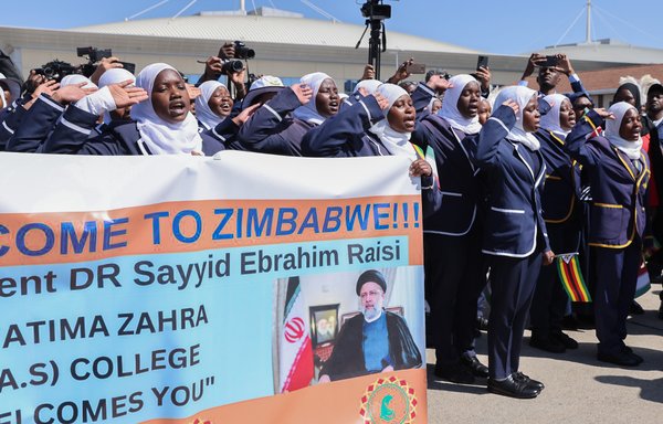 Youth in Zimbabwe hold a banner welcoming Iranian president Ebrahim Raisi to the country -- one of three African countries he visited this week. [president.ir]