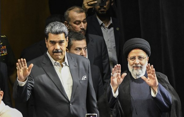 Iran's President Ebrahim Raisi (R) and Venezuela's President Nicolas Maduro (L) arrive for a meeting at the Teresa Carreno theater in Caracas on June 13. Many speculated that Raisi asked for the money Venezuela owes Iran during his June trip to Caracas. [Stringer/AFP]