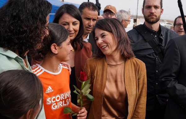 German Foreign Minister Annalena Baerbock visits the Rwanga camp for displaced Yazidis in Qadia village of Iraq's Kurdish region on March 8. A German court was the first in the world to recognise crimes against the Yazidi community as genocide. [Ismael Adnan/AFP]