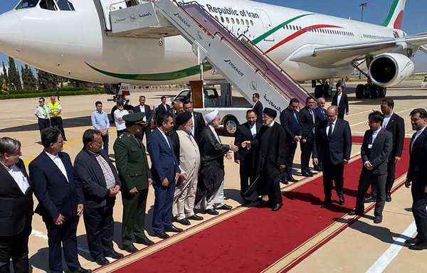 Iranian President Ebrahim Raisi greets officials after arriving at Damascus International Airport on May 3. [AFP]