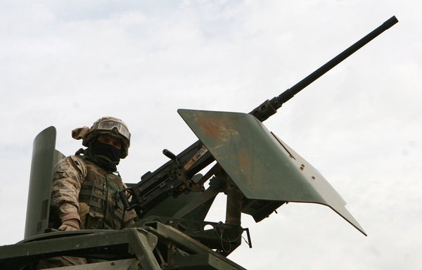 US Marine Lance Cpl. Stephen E. Davis of II MEF stands behind an M2 heavy machine gun in Camp Fallujah in Iraq on January 23, 2006. II MEF fought insurgents in Anbar province, Iraq. [US Marine Corps/Cpl. Ruben D. Maestre]
